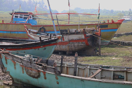 Wooden boats parked at dry land after fishing in Indiaの写真素材