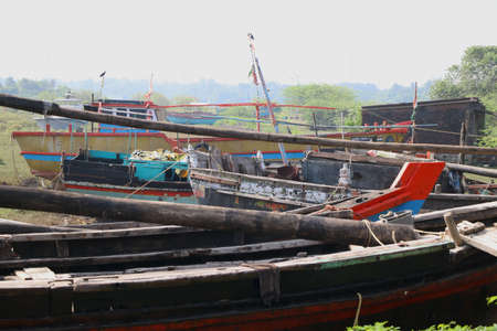 Wooden boats parked at dry land after fishing in Indiaの写真素材