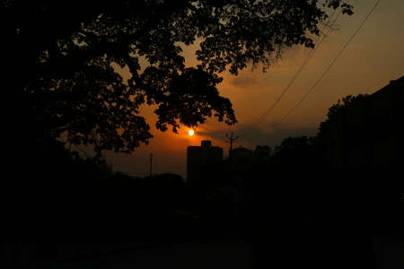 Sunset view with dark black and orange background of buildingの写真素材