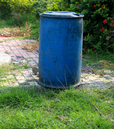 Blue plastic water drum (water barrel) kept outdoorの写真素材