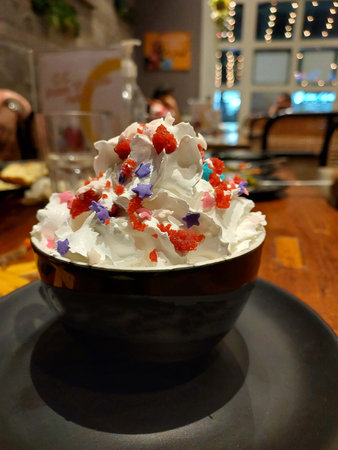 Ice cream served in black cup in restaurantの写真素材