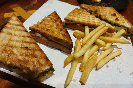 sandwich, and french fries served in plate in restaurantの写真素材
