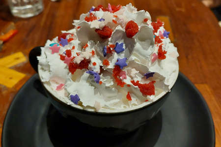 Ice cream served in black cup in restaurantの写真素材