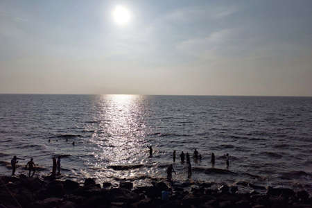 Beach view with people are swimming and bathing in waterの写真素材