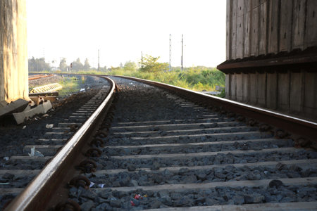 scenic view of curved railway tracks disappearing into the distant horizonの写真素材