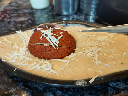 Malai Kofta Curry in black bowl. Malai Kofta is indian cuisine dish with potato and paneer cheese deep fried balls in onion tomato gravy with spices. Indian Food.の写真素材
