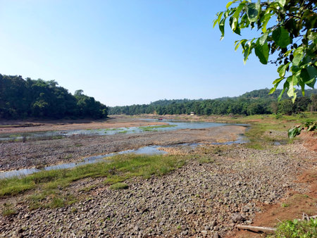 Landscape view of river get dry near waterfall and blue sky and green treesの写真素材