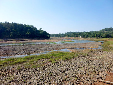 Landscape view of river get dry near waterfall and blue sky and green treesの写真素材