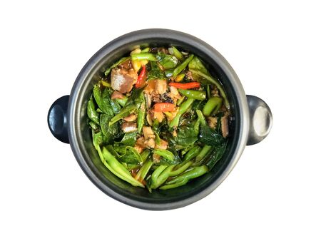 STIR FRIED CHINESE KALE WITH CANNED FISH taste spicy with chili cooking in the black pot isolated in white background has copy space and clipping path, healthy Thai food Ingredients for healthy life.の写真素材