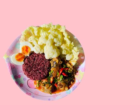 Canned fish spicy sour salad eat with rice berry, egg boiled, cauliflower and Chinese cabbage in pink flower plate, has copy space and clipping path. Healthy Thai food for healthy lifestyle diet food.の写真素材