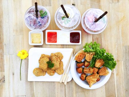 Break time with snack meal, nugget and Thai snack (fried flour inside with pork and shrimp) drinking...