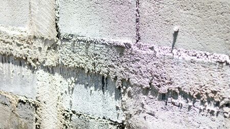 Brick white rough dirty wall. Use for Texture and background. Rock pattern old vintage style using...