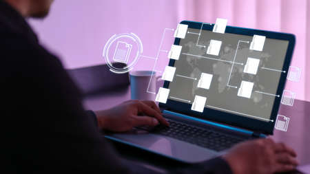 User working on laptop with virtual screen of Document Management System (DMS), a virtual online documentation database. Concept for business and office management. Selective focusの写真素材