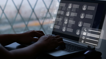 User typing on a laptop with virtual screen of directory contact. Concept for contact us.の写真素材