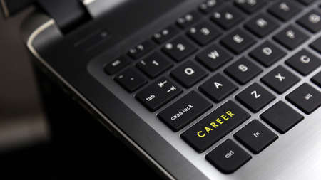 Laptop keyboard button with CAREER word. Concept for human resources and business.の写真素材