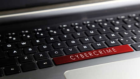 Laptop keyboard button with CYBER CRIME word. Concept for cyber crime awareness.の写真素材