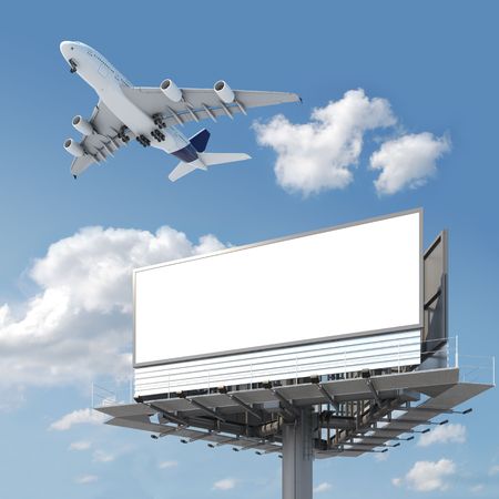 Big empty billboard with copy space for your image or text with an airplane flying on the sky, ideal for travel or vacation promotionsの写真素材