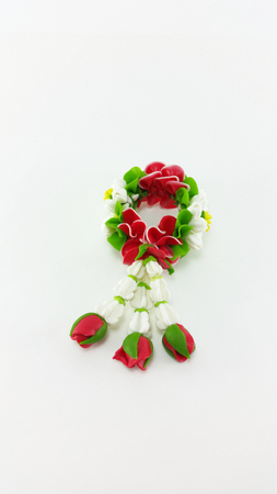 Miniature artificial flower garland on white backgroundの写真素材