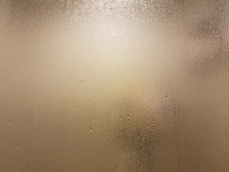 Frost on shower glass with water drops abstract backgroundの写真素材