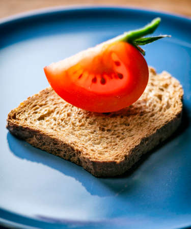Tomato slice on breadの写真素材
