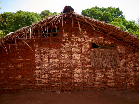 Kenya house made of tree limbs and mud with thatched roofsの写真素材