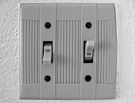 Abstract, electrical switches on-on isolated on a white wall
