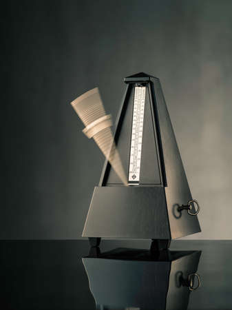 Still life photo of black metronome on grey backgroundの写真素材