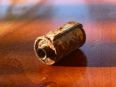 Old rusty photo film rolls cassette on wooden backgroundの写真素材
