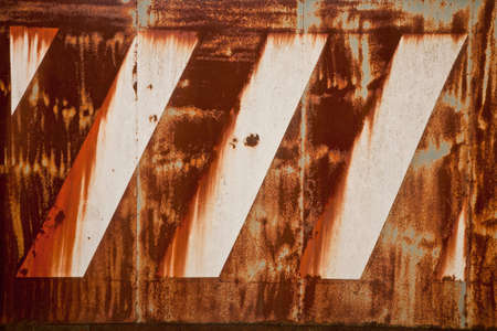 Old rusty metal surface with faded paintの写真素材