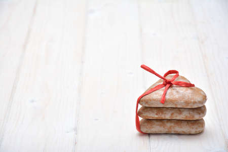 Gingerbreads on the white, wooden surfaceの写真素材