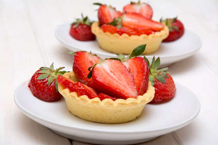 Delicious cakes with fresh strawberries and creamの写真素材