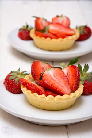 Delicious cakes with fresh strawberries and creamの写真素材
