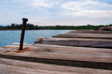 Close up rusty nail on a pier in a harborの写真素材