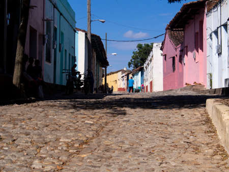 Cobblestone street in an old city, people on the street, sunny dayの写真素材