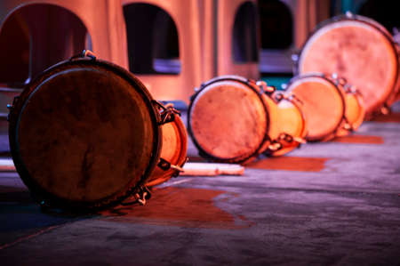 Traditional African drums on a wooden stage, stage lights