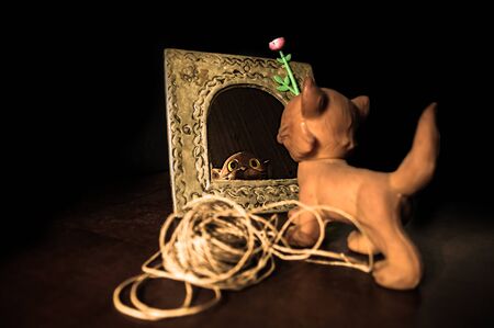 Spooky mirror reflection of an old, vintage rubber cat toyの写真素材
