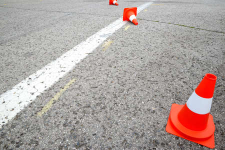 white line on the asphalt and posts warning
