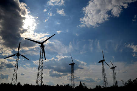 A wind farm or windmills producing energy against the sky