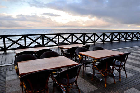empty tables and a boulevard in the seaside resort after the seasonの写真素材