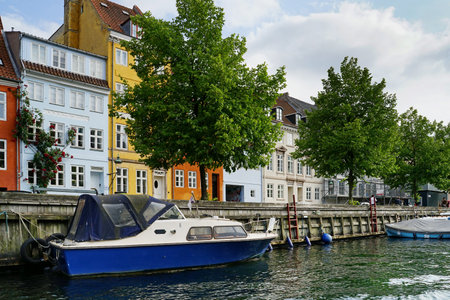 COPENHAGEN, CHRISTIANSHAVN - CIRCA JULY 2022: the wharf seen from the perspective of the boat on the canalのeditorial素材