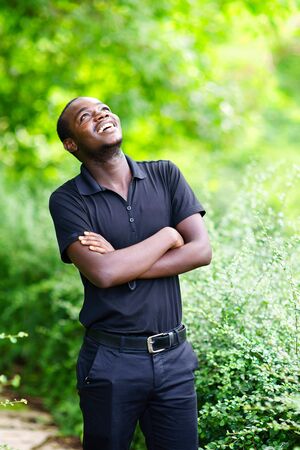 African man looking and thinking in the green nature.の写真素材