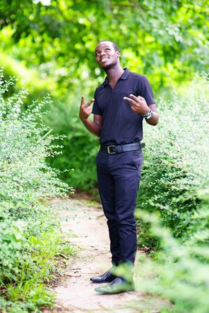 African man looking and thinking in the green nature.の写真素材