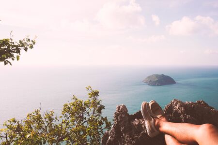 Traveler man hiking canvas shoesnear  ocean on nature background.Travel healthy active lifestyle. Outdoor freedom. Girl feet selfie.の写真素材