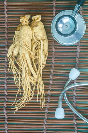 Ginseng and Stethoscope in healthy concept.の写真素材