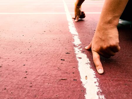 Close up to the hands on starting line