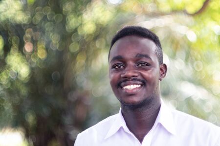 Portrait Of  African Black Man smiling in the green park