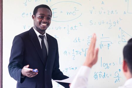African foreign teacher teaching  science in the classroom.の写真素材