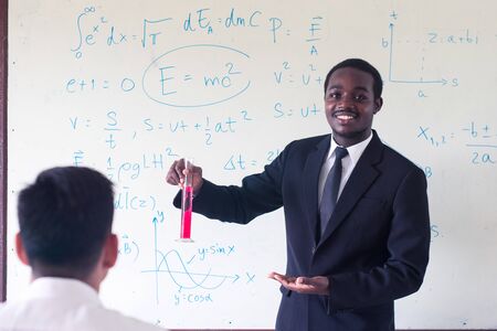 African foreign teacher teaching  science in the classroom.の写真素材