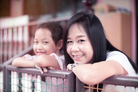 Asian mother and her mother smile at home