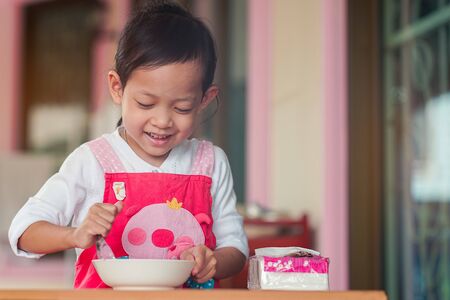 Asian children cooking and smiling with Happiness at homeの写真素材